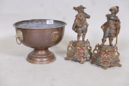 A C19th French hammered copper pedestal bowl with lion mask handles and inset plaques of French