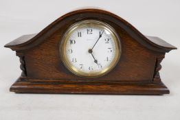 A French oak cased eight day mantel clock with white enamel dial and Arabic numerals, 11" wide