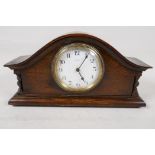 A French oak cased eight day mantel clock with white enamel dial and Arabic numerals, 11" wide