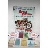 A replica Royal Enfield metal advertising sign, two painted cast iron wall plaques and a