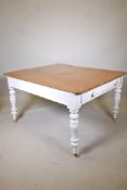 A C19th pine farmhouse scullery table, two end drawers and painted base, raised on turned supports