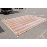 A large contemporary wool rug with a Paul Smith style design, faded in parts, 130" x 180"
