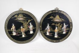 A pair of lacquered chinoiserie plaques with inlaid decoration of female travellers, 16" diameter