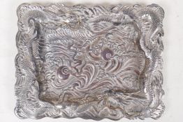 A Chinese silver plated tray embossed with dragons chasing the flaming pearl, 8" x 6"