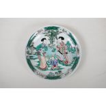 A famille vert porcelain dish decorated with women and children in a garden, Chinese Kangxi