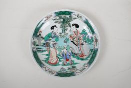 A famille vert porcelain dish decorated with women and children in a garden, Chinese Kangxi