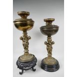 Two table lamps, the central bronze columns cast as two cherubs supporting an urn, with brass oil