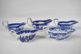 Five late C18th/early C19th English blue and white pottery sauce boats to include Boy on a Buffalo