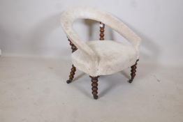 A C19th bow shaped nursing chair raised on bobbin turned supports