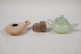 A Chinese carved green jade squat form teapot, Roman terracotta oil lamp, and a carved soapstone