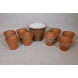 Eight terracotta flower pots and a larger stoneware pot, largest 12" high, 15" diameter