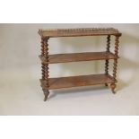 A Victorian figured walnut three tier open shelf, the top with three quarter pierced brass