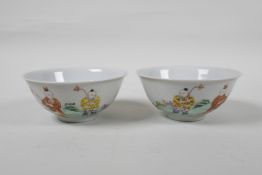 A pair of late C19th/early C20th famille rose porcelain rice bowls decorated with children at