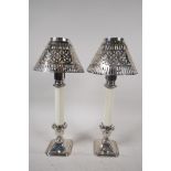 A pair of table candlesticks with pierced silver plated shades on hallmarked silver bases, 12½" high