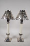 A pair of table candlesticks with pierced silver plated shades on hallmarked silver bases, 12½" high