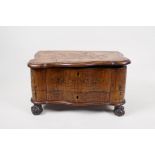 A marquetry inlaid walnut serpentine box on carved ball and claw feet, with a single drawer, 13" x