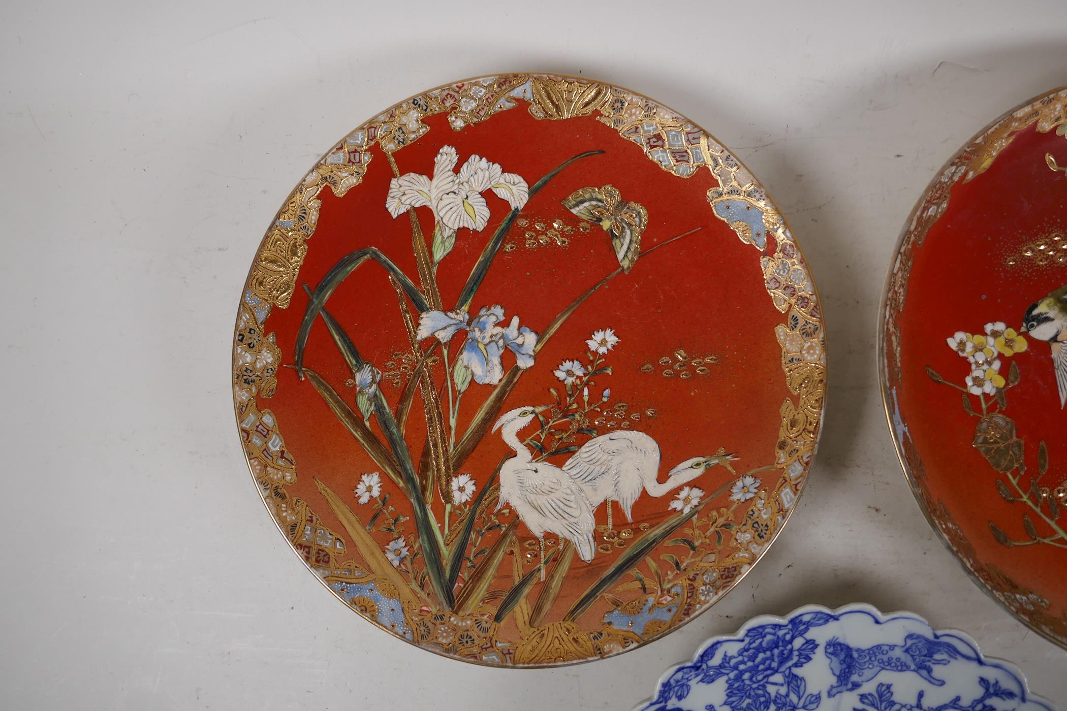 A pair of Japanese red ground pottery cabinet plates with satsuma decoration depicting birds amongst - Image 2 of 4