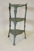 A painted cast iron three tier pot stand, 27" high