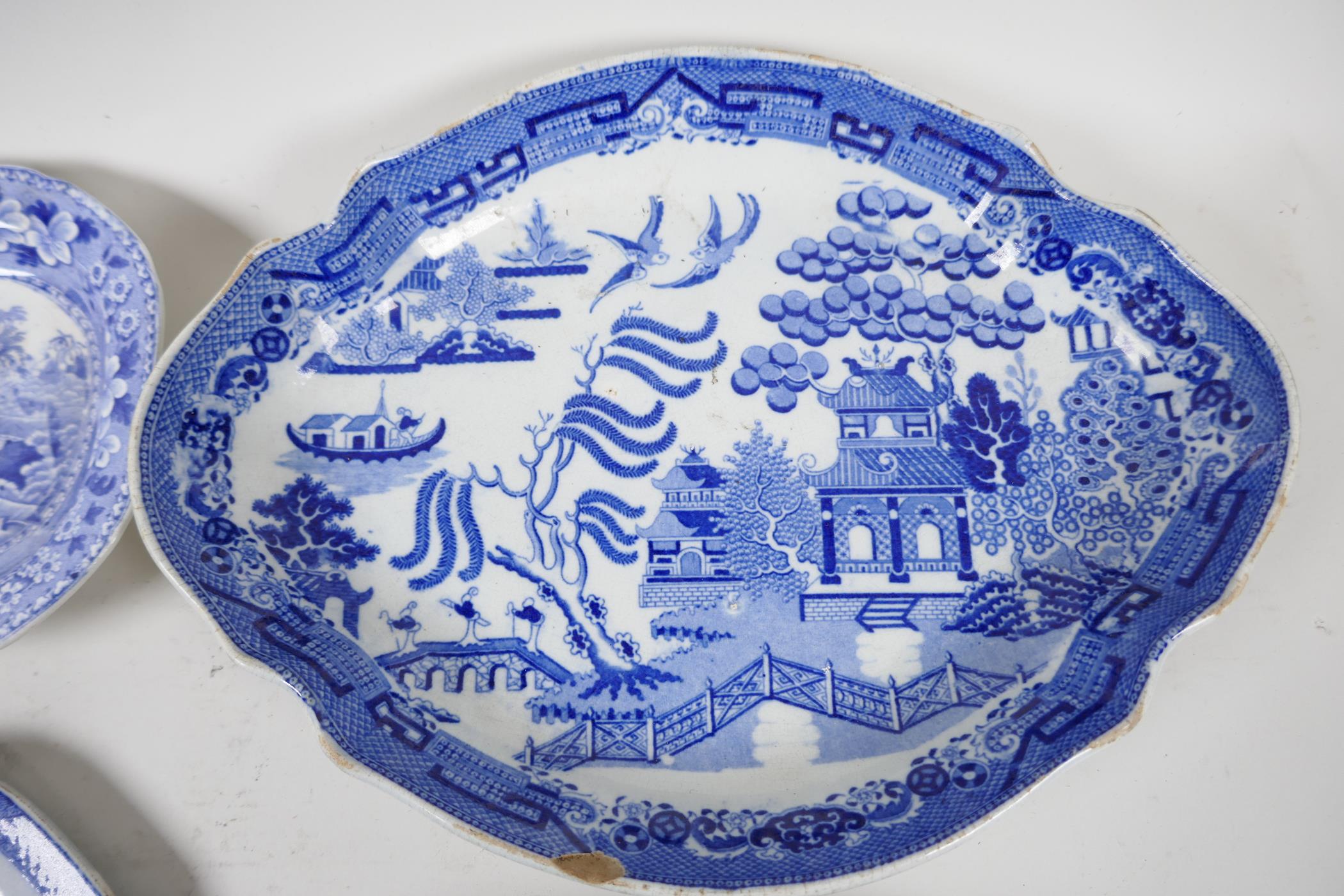 Eight C19th blue and white pottery dishes, various patterns to include the Long Bridge, Boy on a - Image 6 of 7