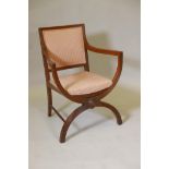 A C19th walnut elbow chair with reeded back and arms, raised on X shaped supports