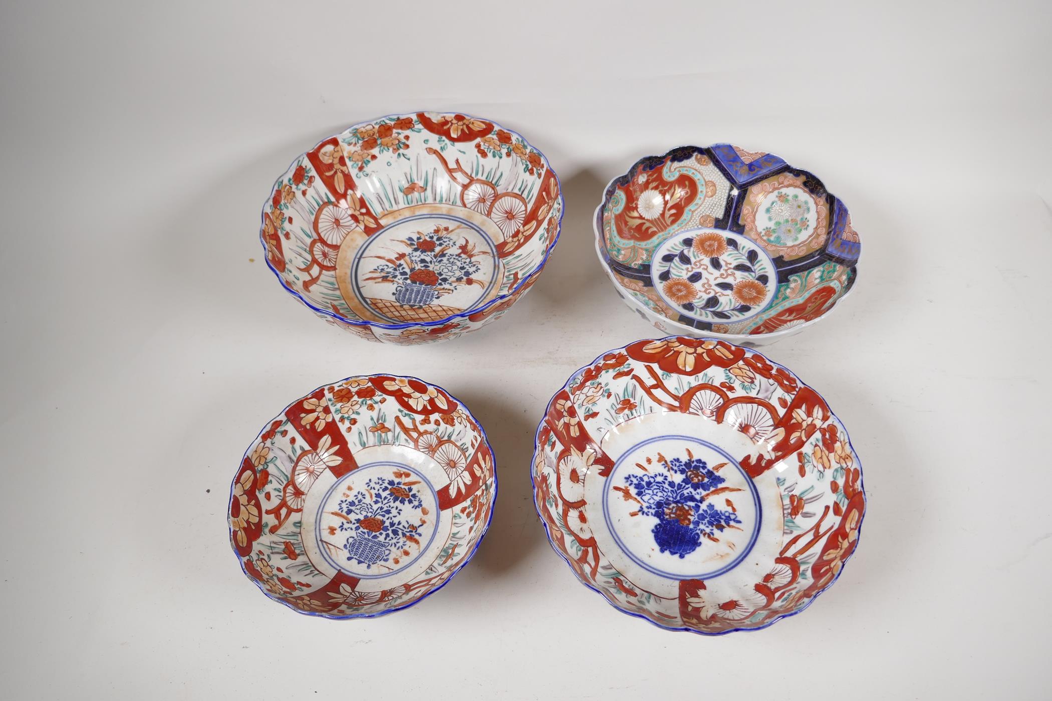 Four C19th Imari porcelain bowls decorated with traditional patterns, largest 10" diameter