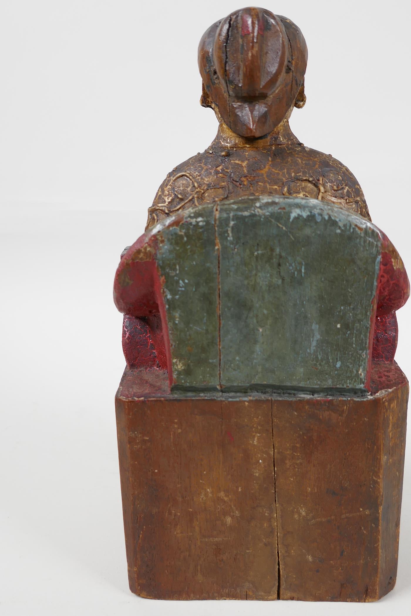 A Chinese carved wood figure of a dignitary seated on a throne, traces of paint, 9" high - Image 4 of 6