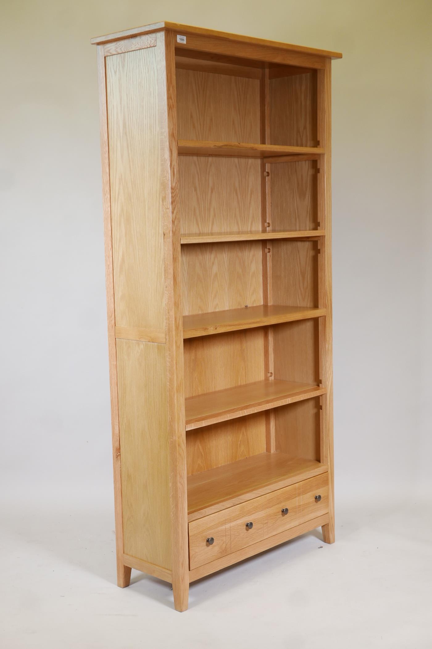 A blonde oak open shelf bookcase, with four shelves and draw to base, supplied by John Lewis, 73" - Image 2 of 3