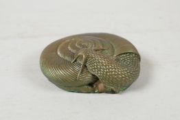 A filled bronze dump weight in the form of a snail, 3½" x 3"