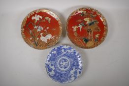 A pair of Japanese red ground pottery cabinet plates with satsuma decoration depicting birds amongst