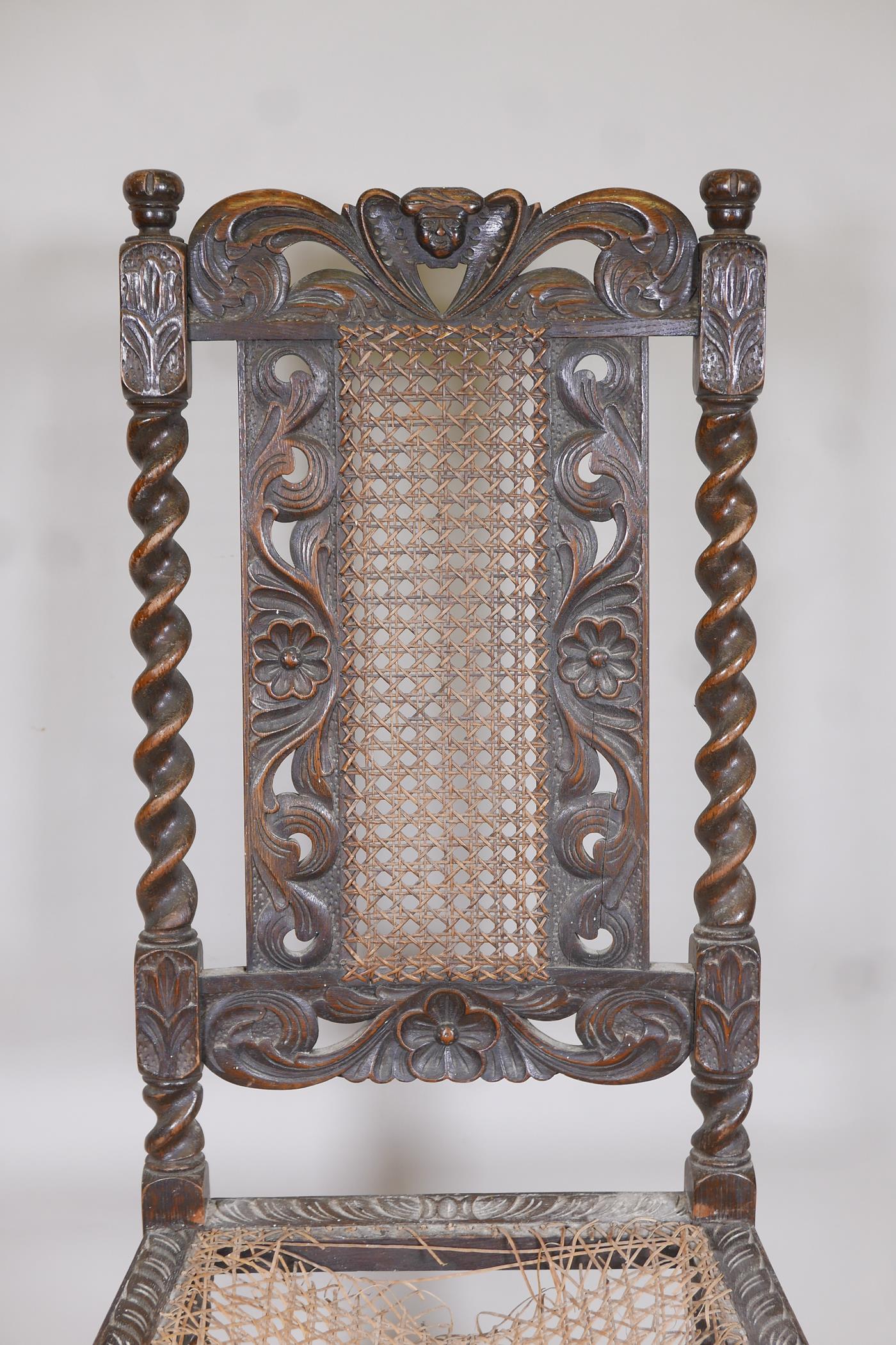 A late C18th/early C19th oak barleytwist chair with a cane seat and back, and carved floral details, - Image 3 of 4