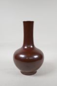 A Chinese copper lustre glazed porcelain bottle vase, impressed Qianlong seal mark to base, 9½" high