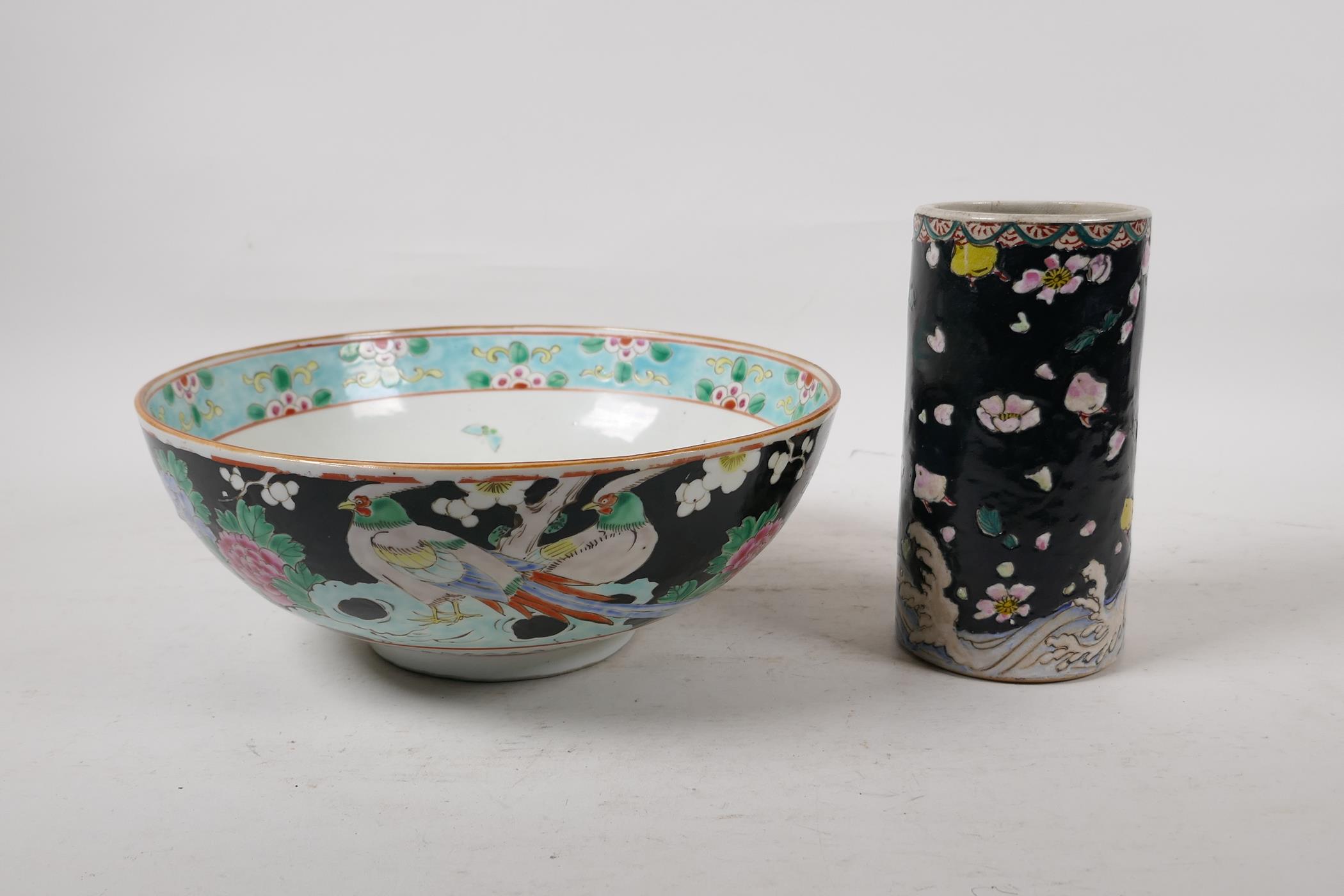 An oriental antique famille noir pottery brush pot decorated with birds and blossom, and a famille