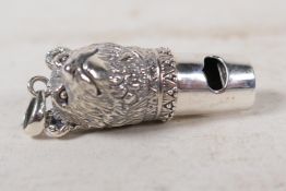 A sterling silver dog whistle cast as a dog's head, 1½" long