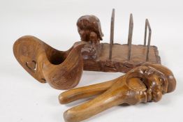 A Black Forest wooden nut cracker carved as a man's head, 8" long, together with a letter rack