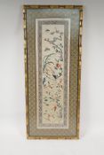 A Chinese silk embroidery of an asiatic bird, flowers and butterfiles, 10½" x 23½"