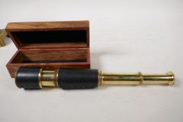 A two draw brass telescope, 13" long extended, in a hardwood box