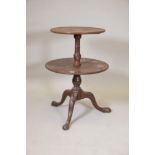 A George III mahogany two tier dumb waiter on a turned and carved column and tripod supports, A/F