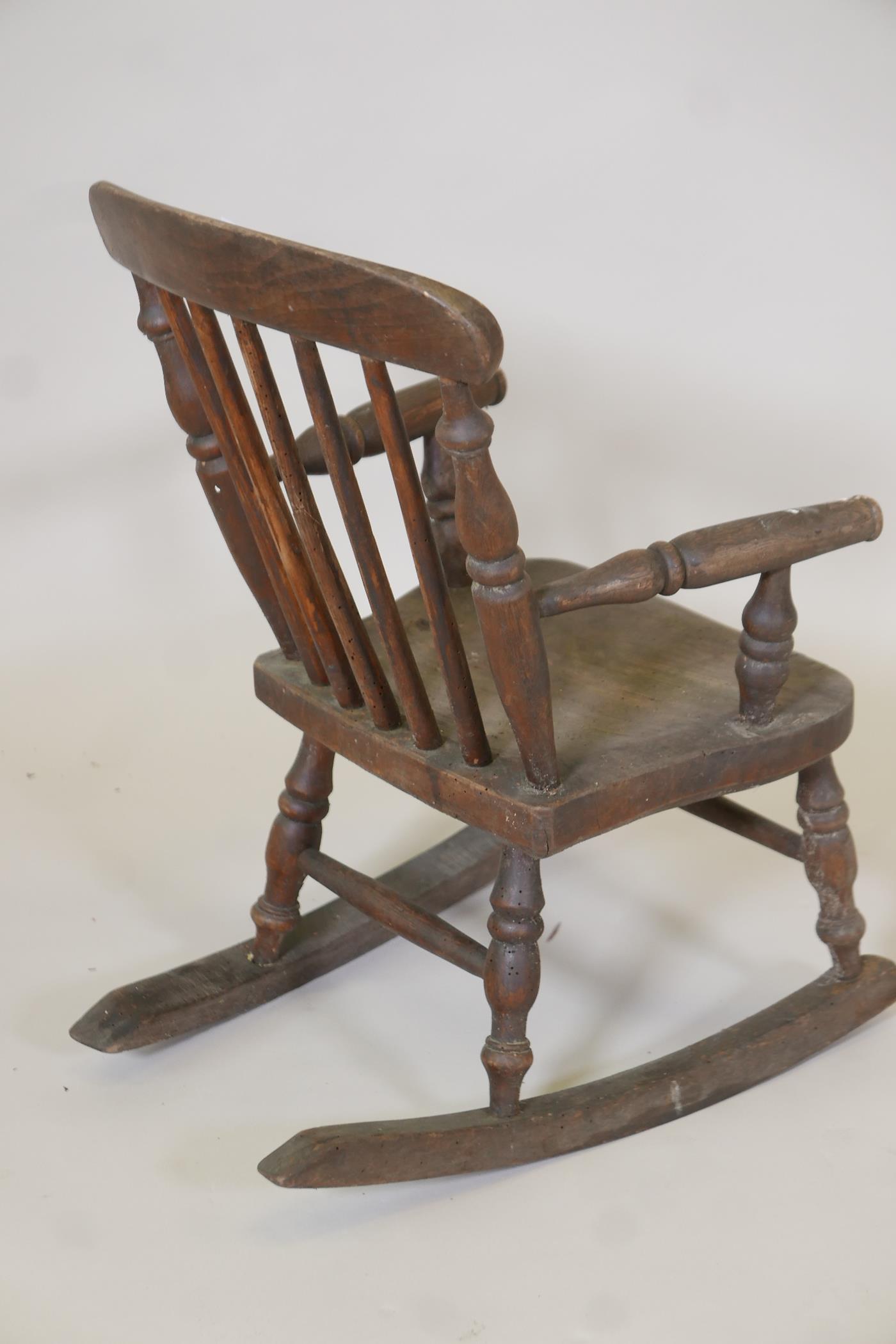 A child's elm Windsor stick back rocking chair, 24" high, 11" wide - Image 3 of 4