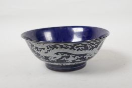 A powder blue glazed porcelain rice bowl with white enamel dragon decoration, six character mark