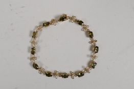 A 10ct yellow gold, diamond and tourmaline set bracelet, 6" long