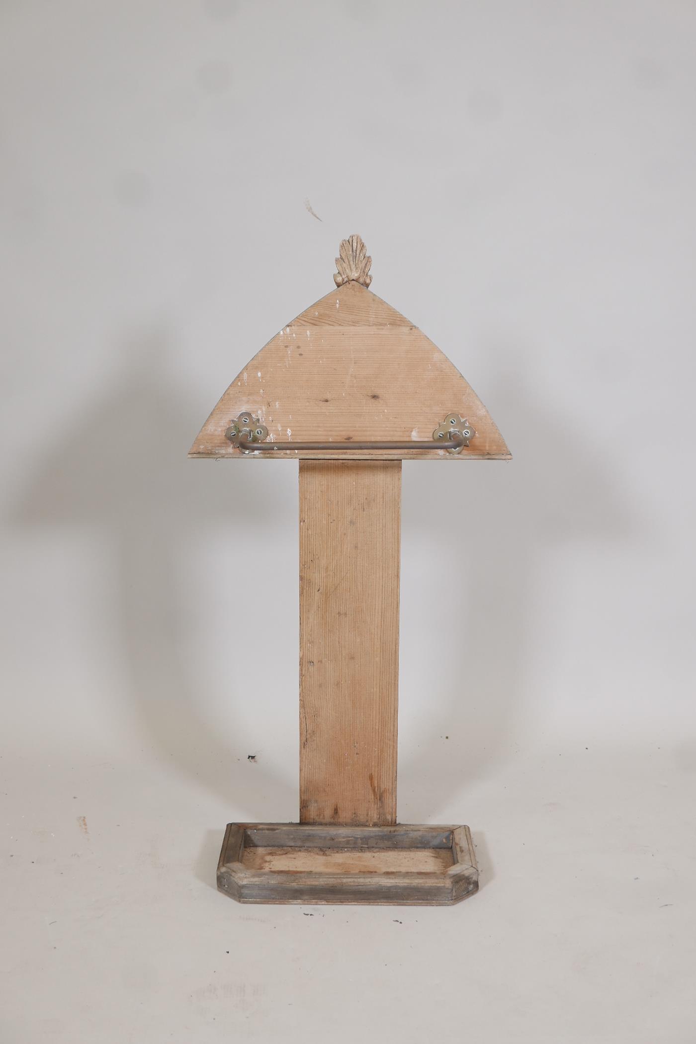 A C19th stripped pine stick stand with a carved finial, 31" high