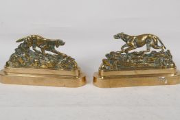 A pair of C19th brass book ends cast as stalking dogs, 8" long