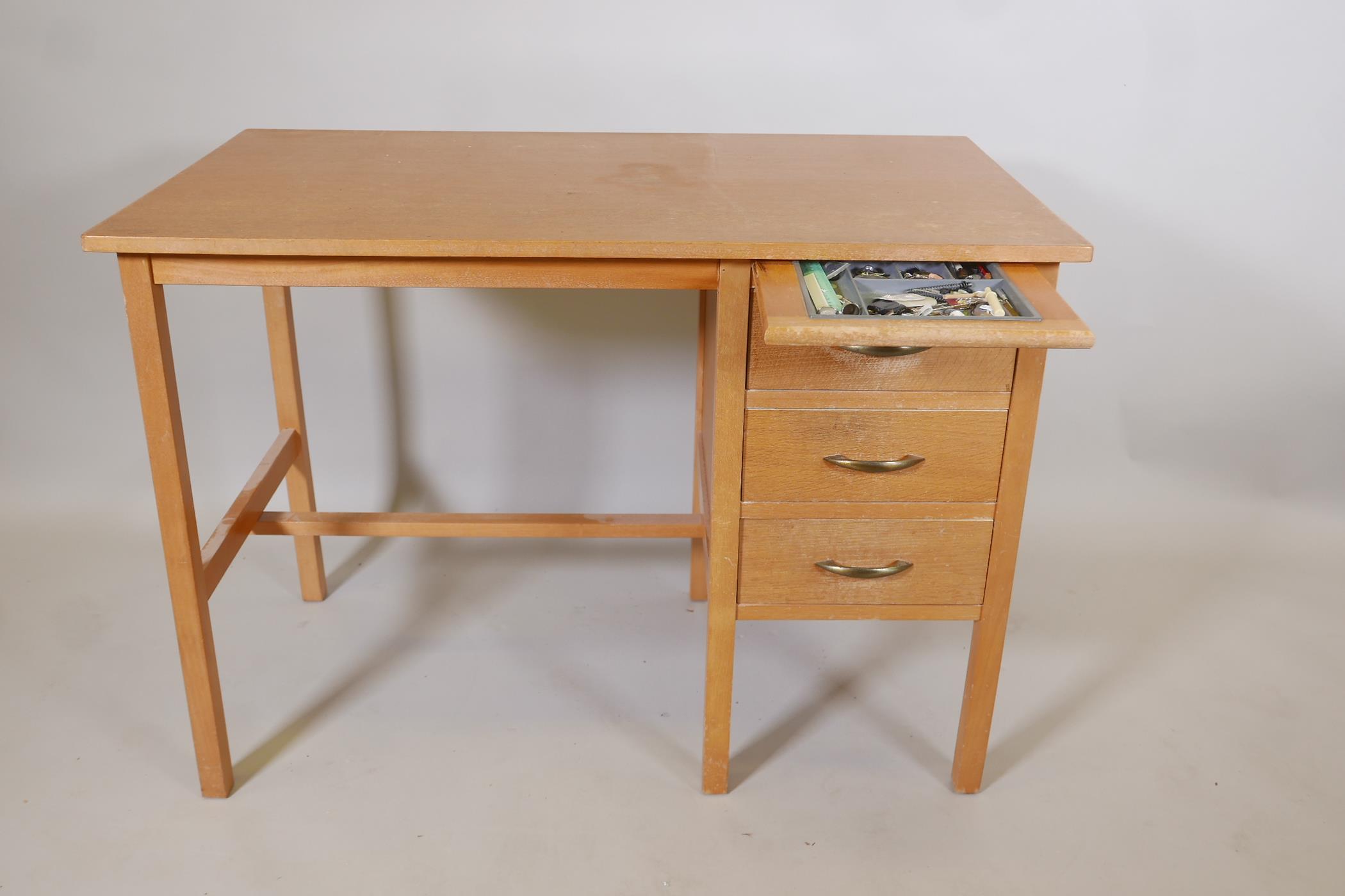 A light oak utilitarian three drawer desk with a stationery slide, 42" x 24", 30" high - Image 3 of 3