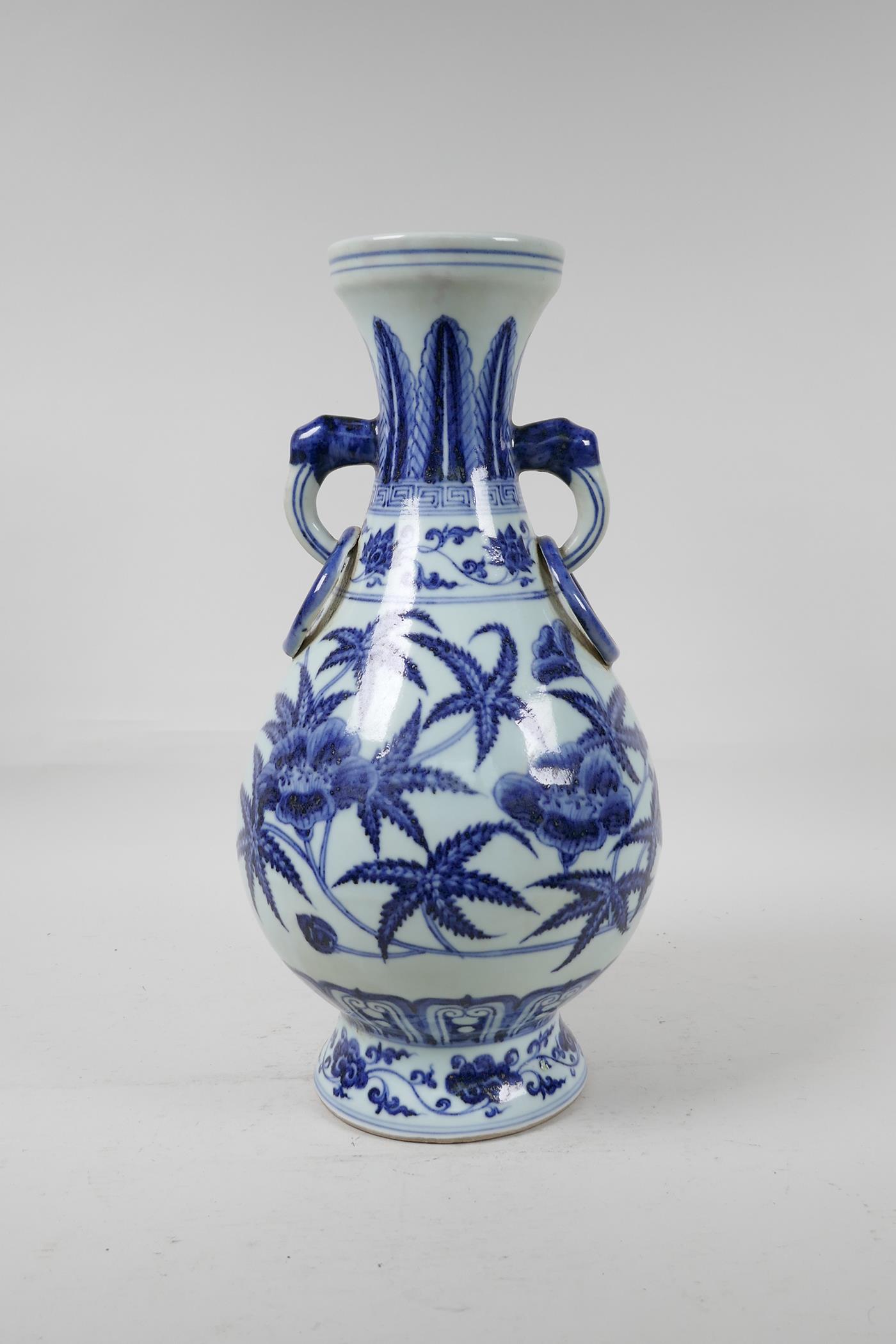 A blue and white porcelain vase with floral decoration, Chinese six character mark to side, 13½"