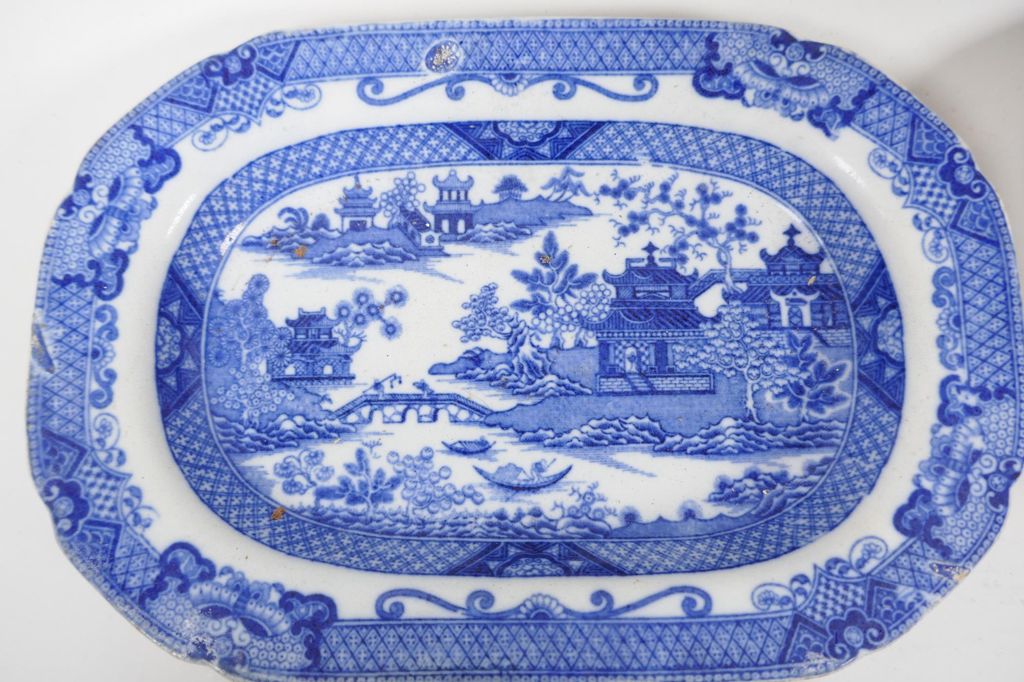 Eight C19th blue and white pottery dishes, various patterns to include the Long Bridge, Boy on a - Image 2 of 7
