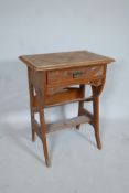 A satin walnut canterbury with carved Moorish Liberty style decoration and single drawer, A/F,