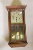 An early C20th mahogany cased wall clock with Westminster chime movement, silvered dial and arabic