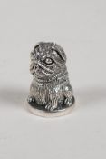 A sterling silver thimble in the form of a pug dog, 1" high