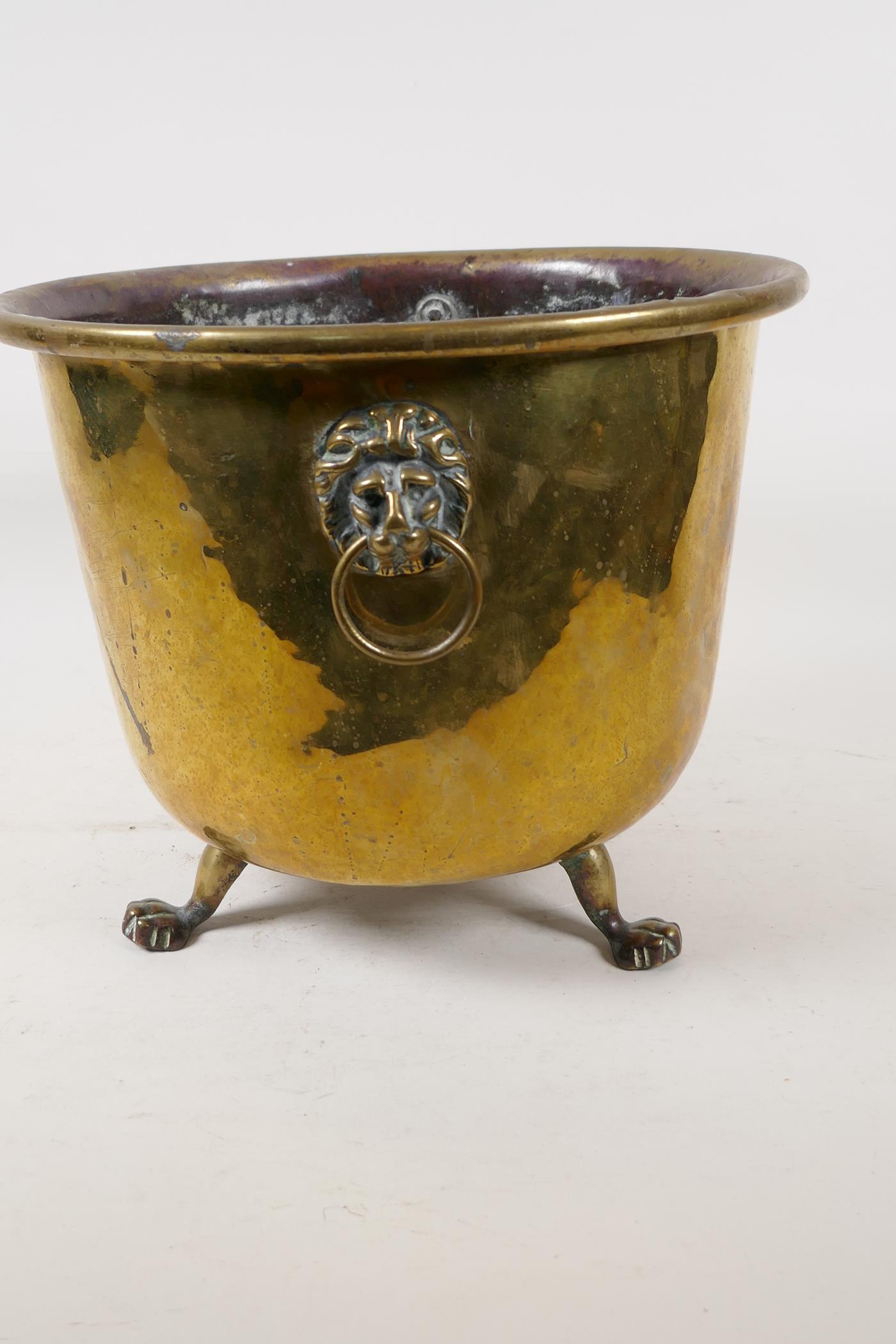 A C19th polished brass jardiniere with lion mask handles and three paw feet, 9" high - Image 2 of 4