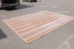 A large contemporary wool rug with a Paul Smith style design, faded in parts, 130" x 180"